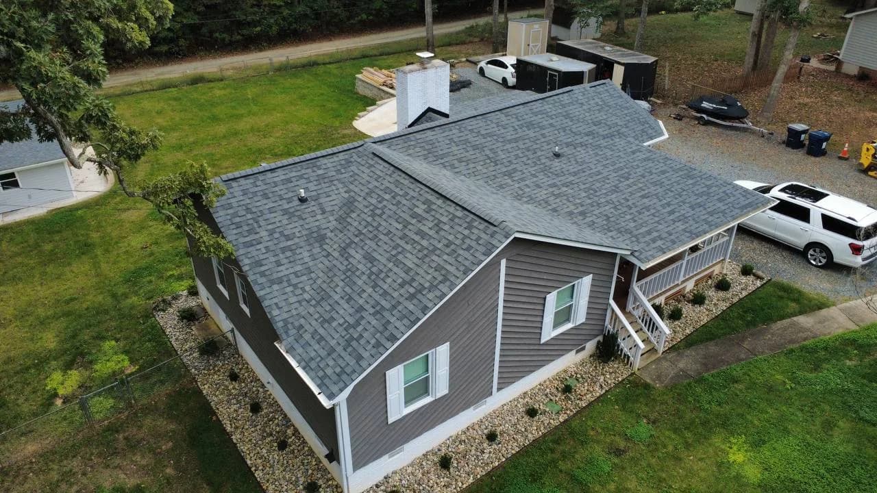 Drone photo of architectural shingle roof replacement on a gray ranch home by Local Roofer NC